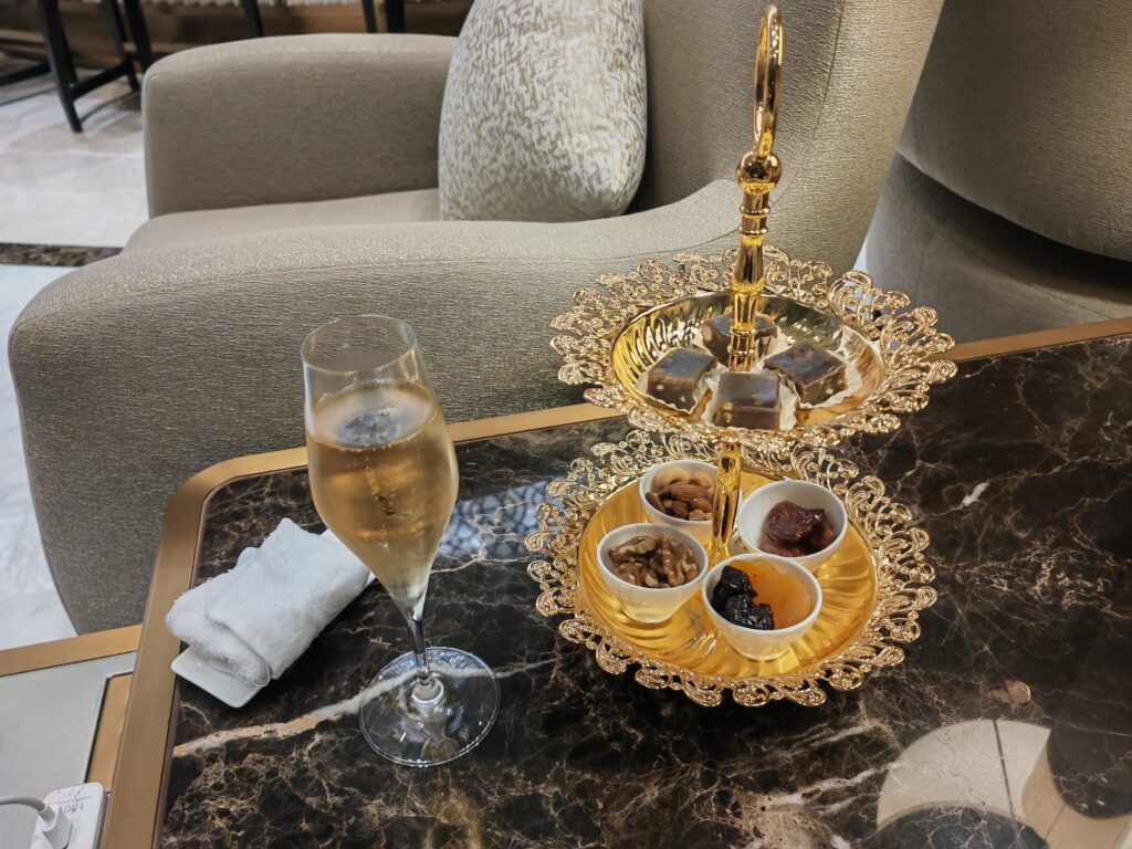 Oman Air First Class Lounge MCT Welcome Cristal Champagne Dates